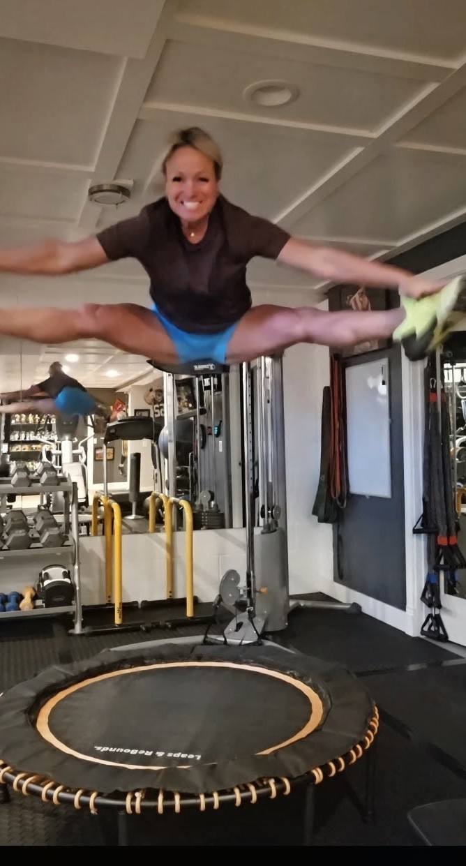 Woman jumping on a trampoline as a fun way to increase daily activity and burn more calories through movement.