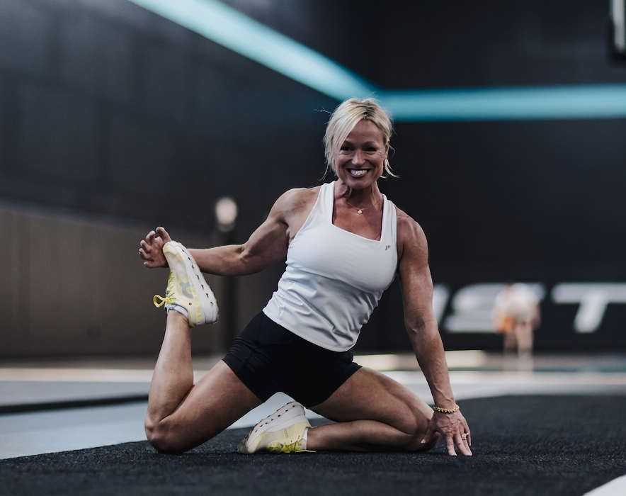 Kelly Meyer exercising during a fitness workout, representing strength, healthy weight loss, and sustainable lifestyle habits with GLP-1 coaching.